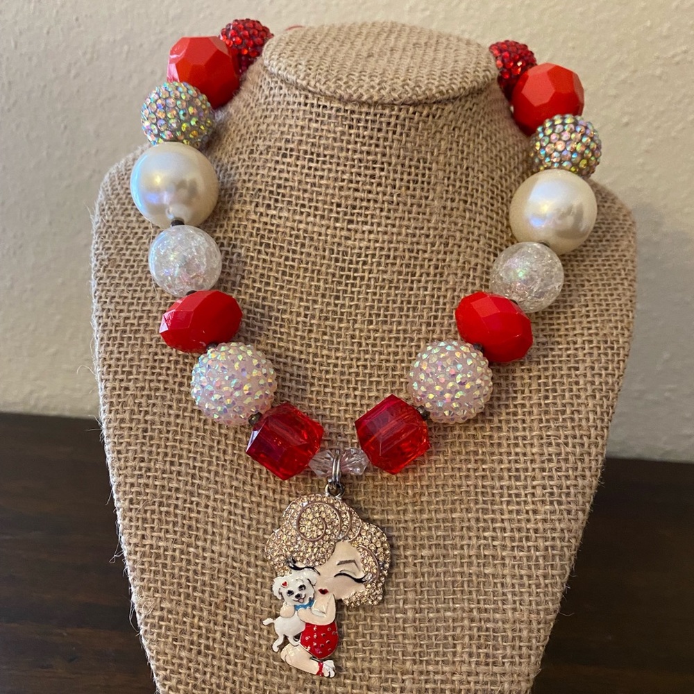 Girl with puppy red and white bubblegum necklace